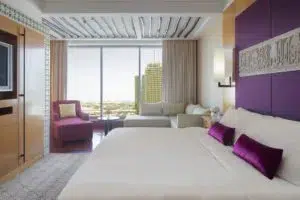 Exclusive Dubai hotel room featuring elegant purple details and a comfortable king-size bed