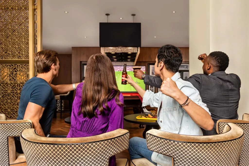 Beer and enjoyment with friends watching Tv in a Resort in Dubai