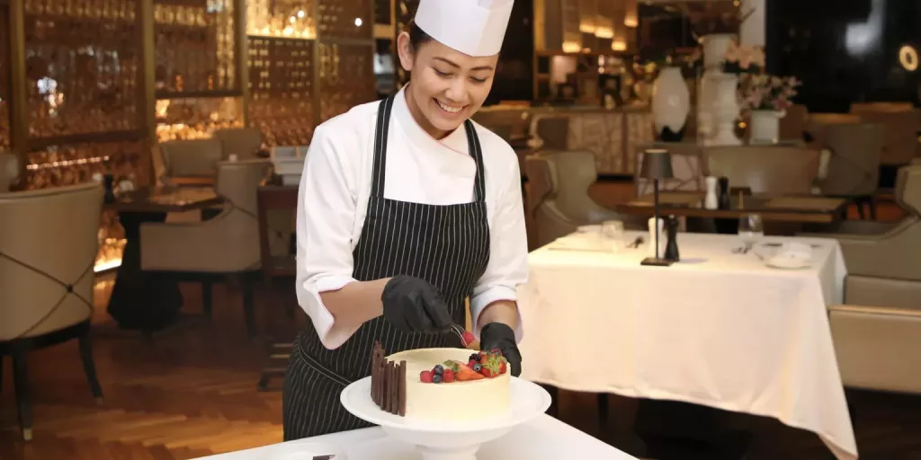 A chef preparing a delicious fruit cake during a cooking class in Dubai